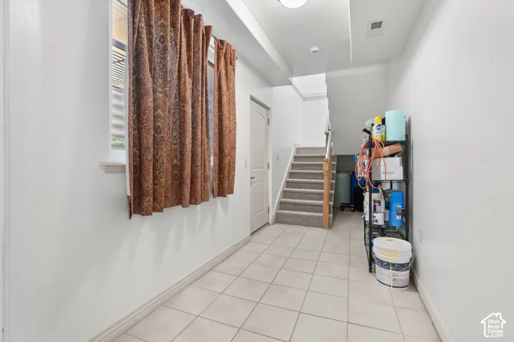 Basement hallway with tiled flooring