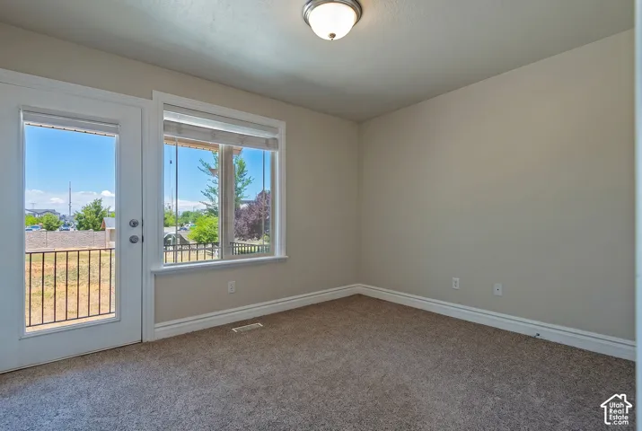 Room featuring neutral carpet flooring, white baseboards, and light-colored walls