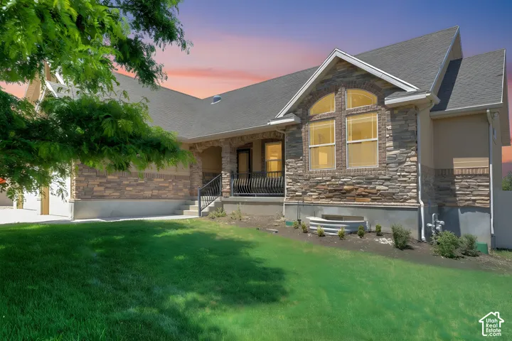 Stone and stucco exterior with an arched window accent