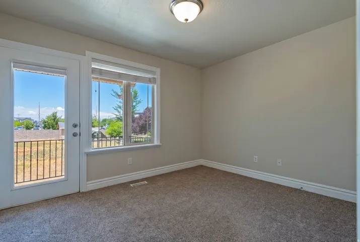 Room featuring neutral carpet flooring, white baseboards, and light-colored walls