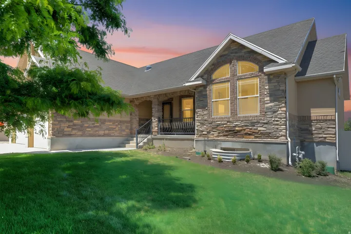 Stone and stucco exterior with an arched window accent