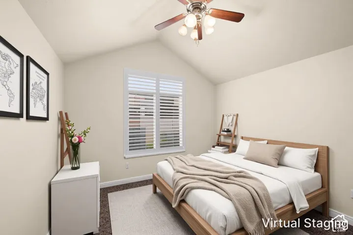 Vaulted ceiling featuring a ceiling fan with integrated lighting, window with white louvered shutters, and carpet flooring