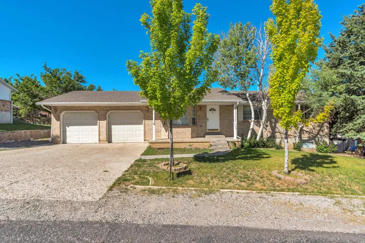 Brick exterior with a two-car garage and a concrete driveway