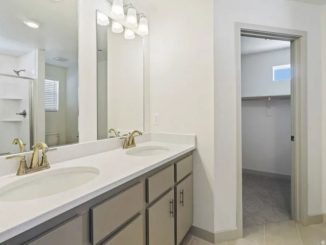 Dual vanity with light-toned countertops and undermount sinks