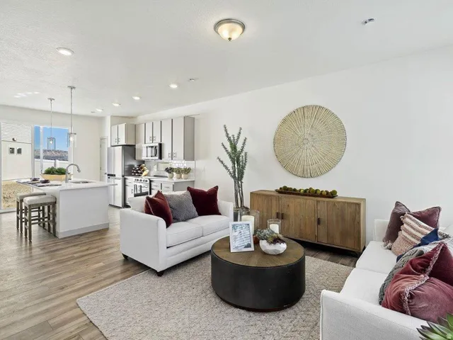 Open-concept living space featuring wood-finish flooring and recessed lighting