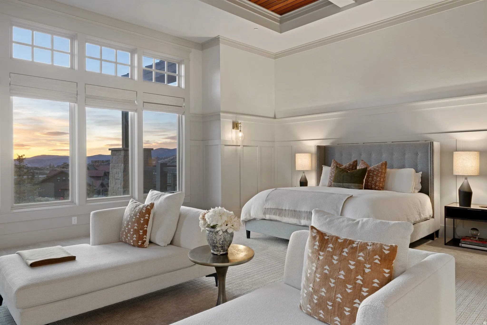 Spacious room featuring multiple large windows with transom details, high ceilings, recessed lighting, and elegant wainscoting