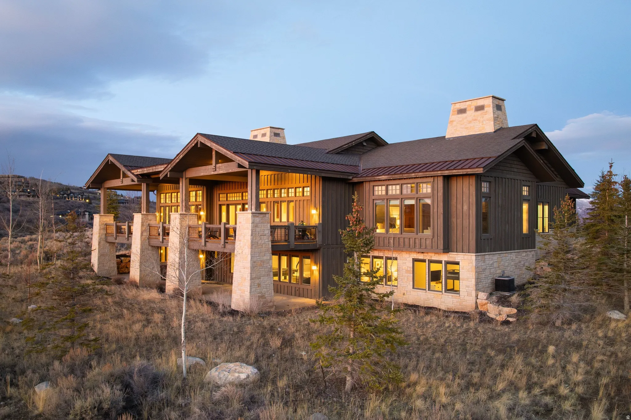 Multi-level residence featuring extensive natural wood siding and stone accents