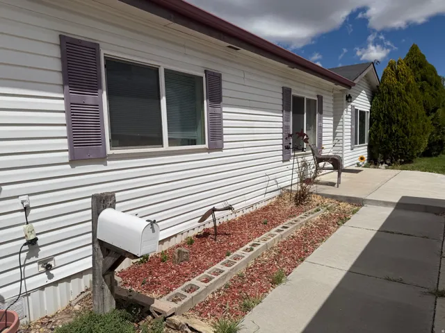 White vinyl siding exterior with purple decorative shutters