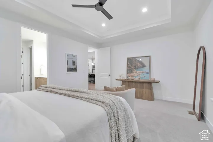 Tray ceiling featuring recessed lighting and a matte black ceiling fan