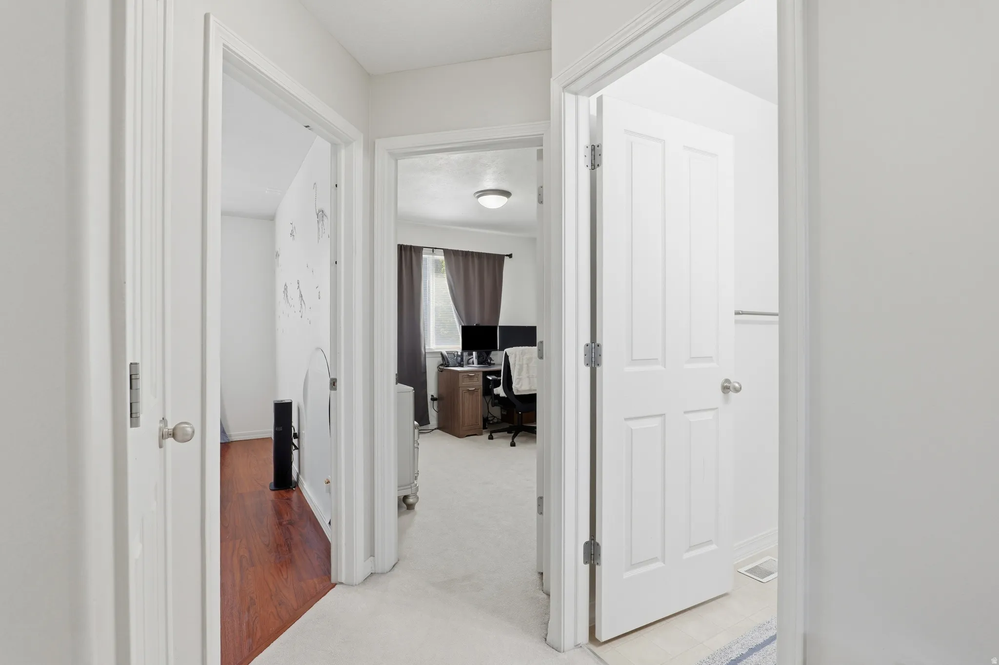 White interior doors and trim with a neutral wall color throughout