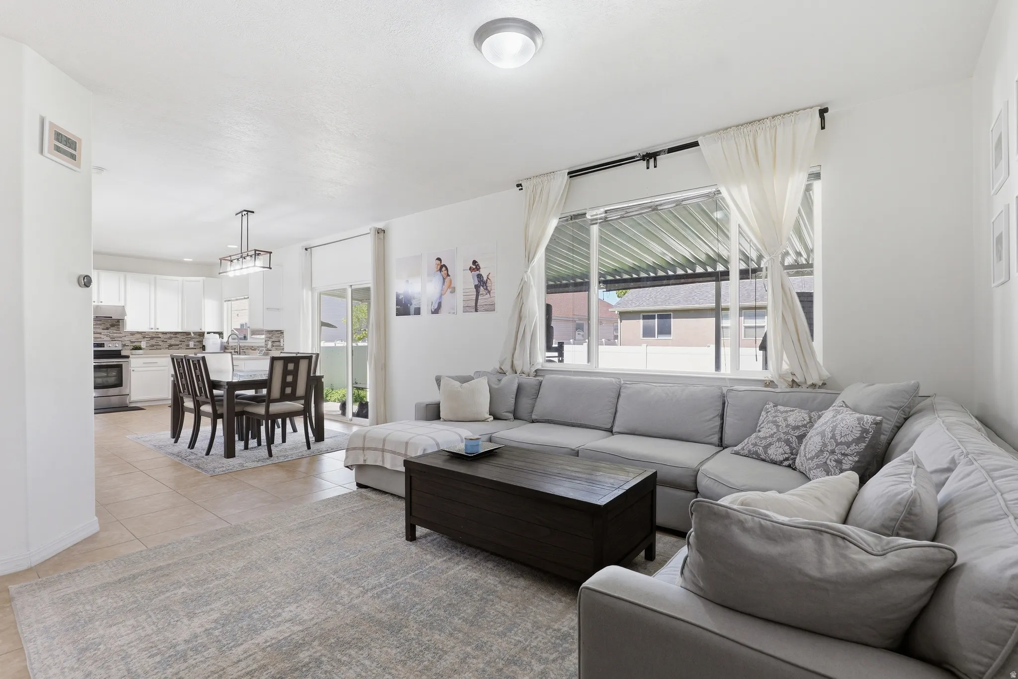 Open concept living space featuring a bright living room, dining area, and kitchen