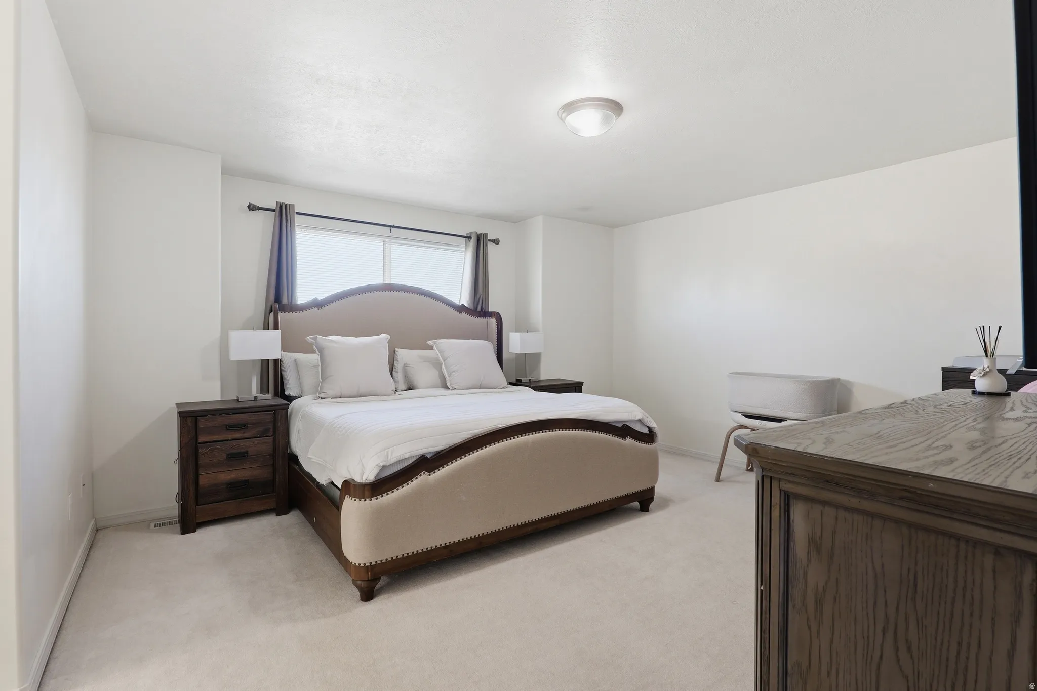 Bedroom featuring neutral-toned carpeting and white wall finishes