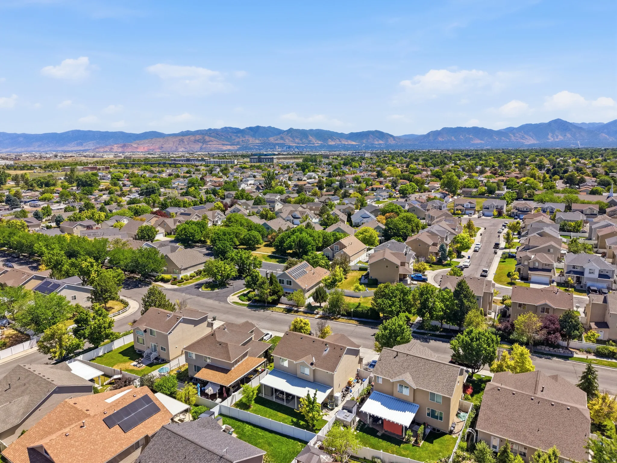 Residential development featuring mature trees and mountain scenery