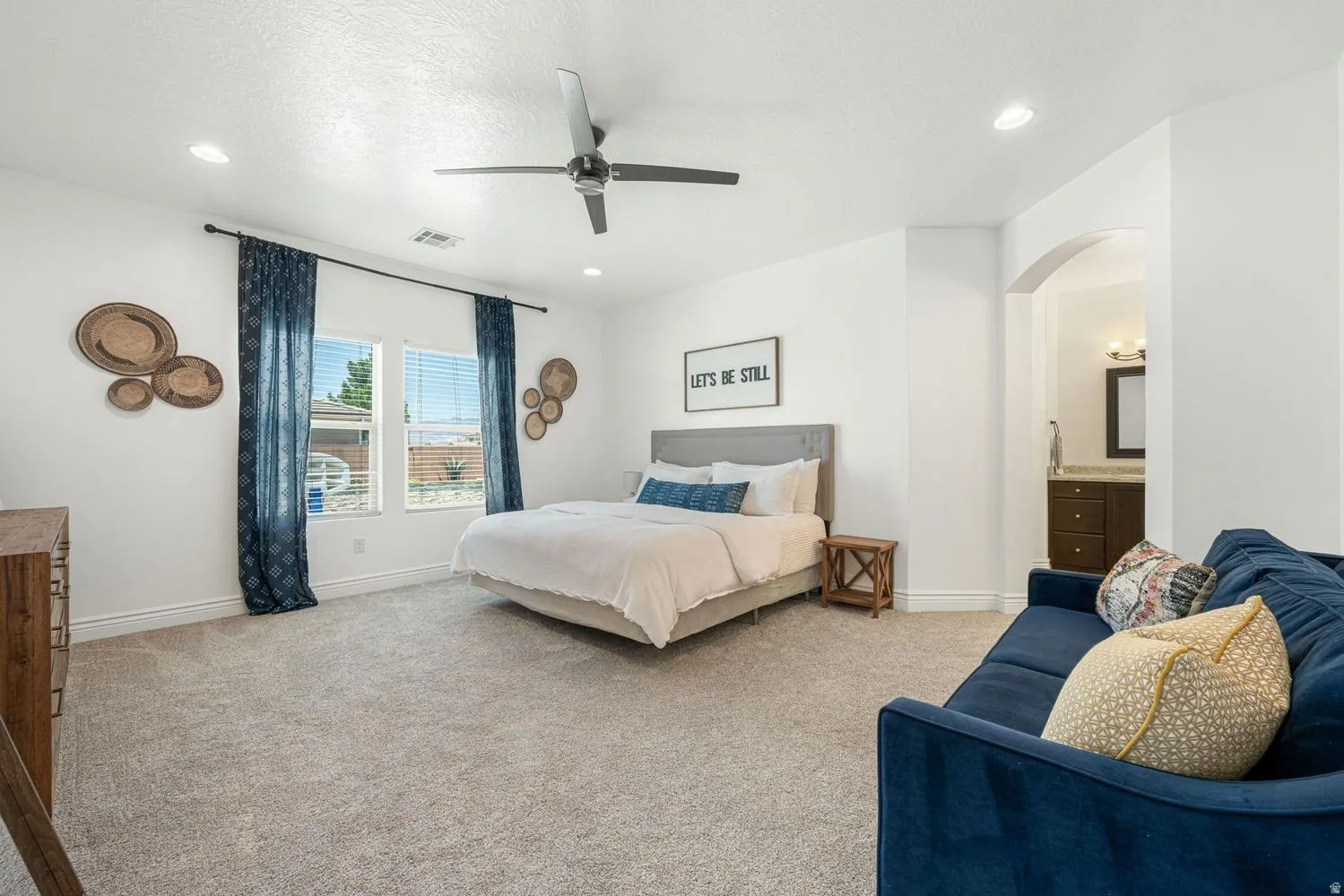 Spacious room with plush carpeting, recessed lighting, and a ceiling fan