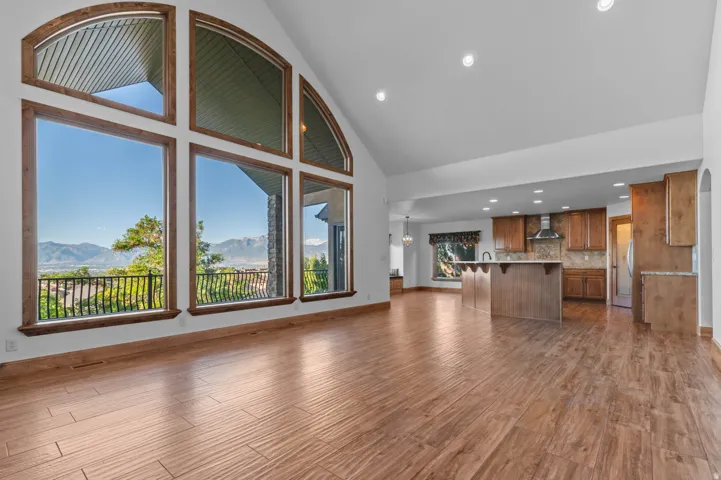 Vaulted ceilings with recessed lighting complement the wood-finish flooring. Large picture windows with arch details. Amazing valley and mountain views.