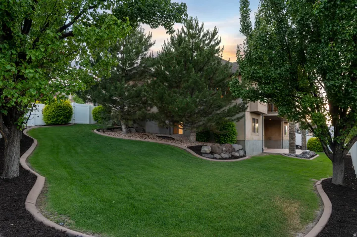 Expansive lawn bordered by concrete curbing and dark mulch