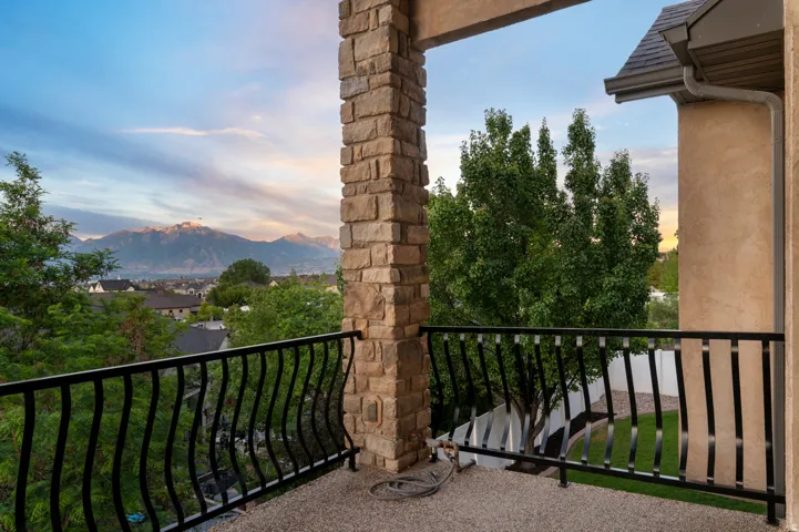 Balcony  from main living room with stone pillars and wrought iron railing