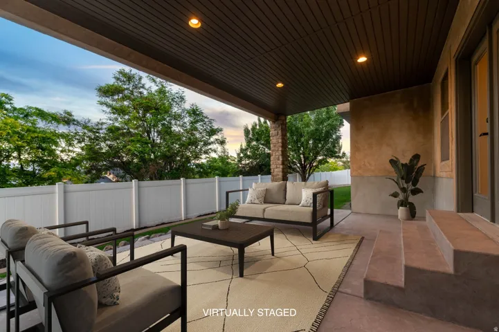 *Virtually Staged Image* Covered patio featuring recessed lighting, a smooth concrete floor, and textured stucco walls