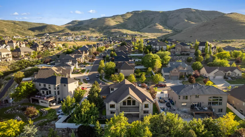 Residential community situated among rolling hills, featuring mature landscaping and diverse home styles