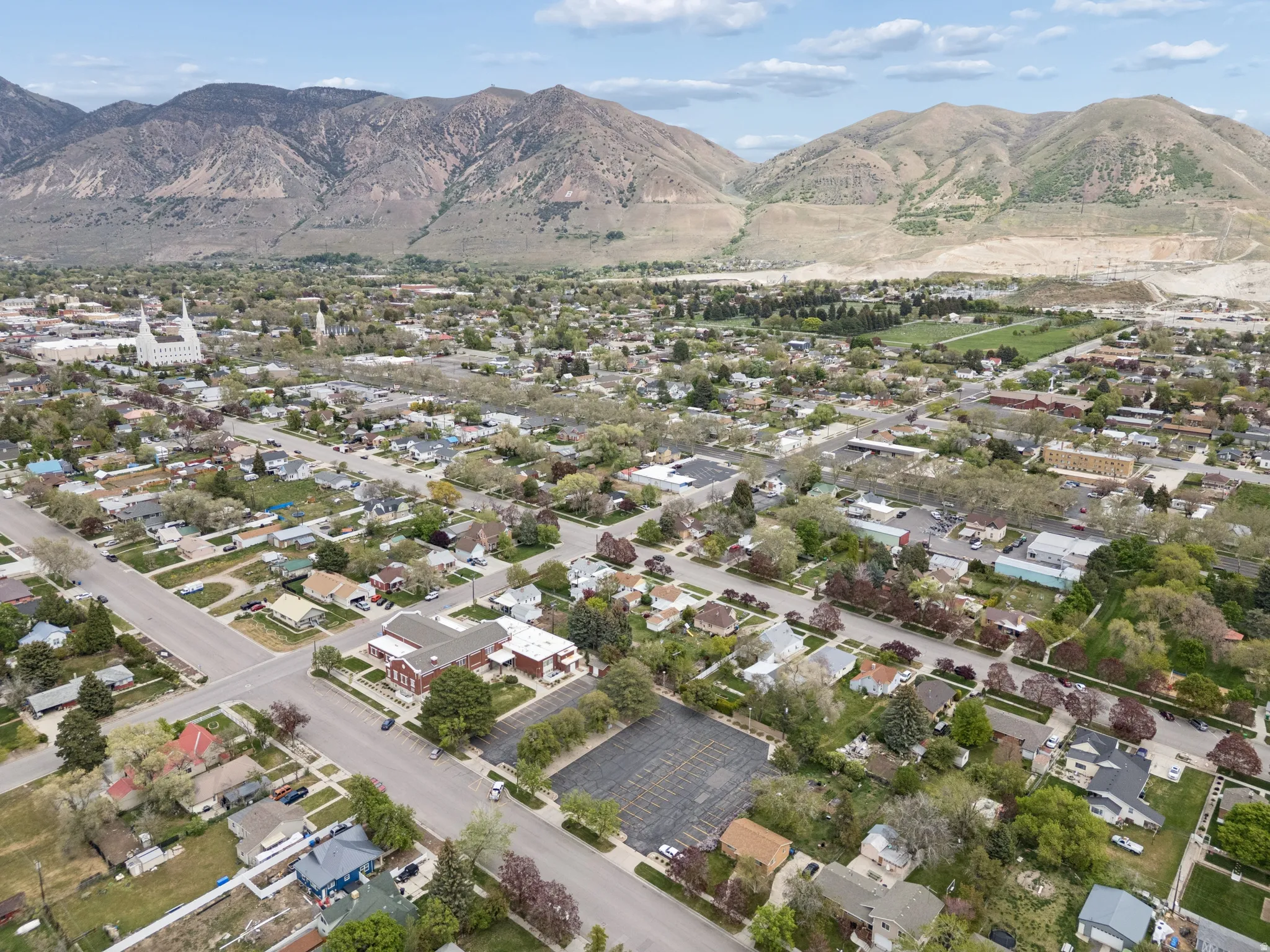 Expansive aerial perspective showcasing a residential neighborhood with established homes and mature trees