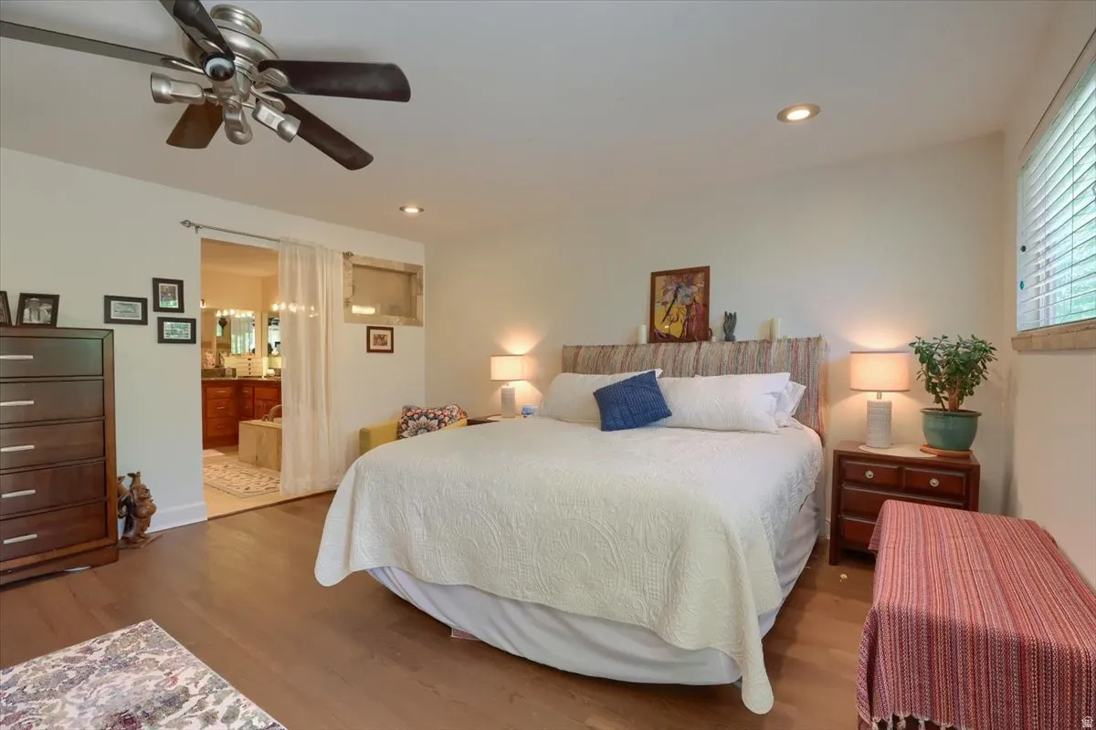 Expansive room featuring wood-finish flooring, recessed lighting, and a ceiling fan