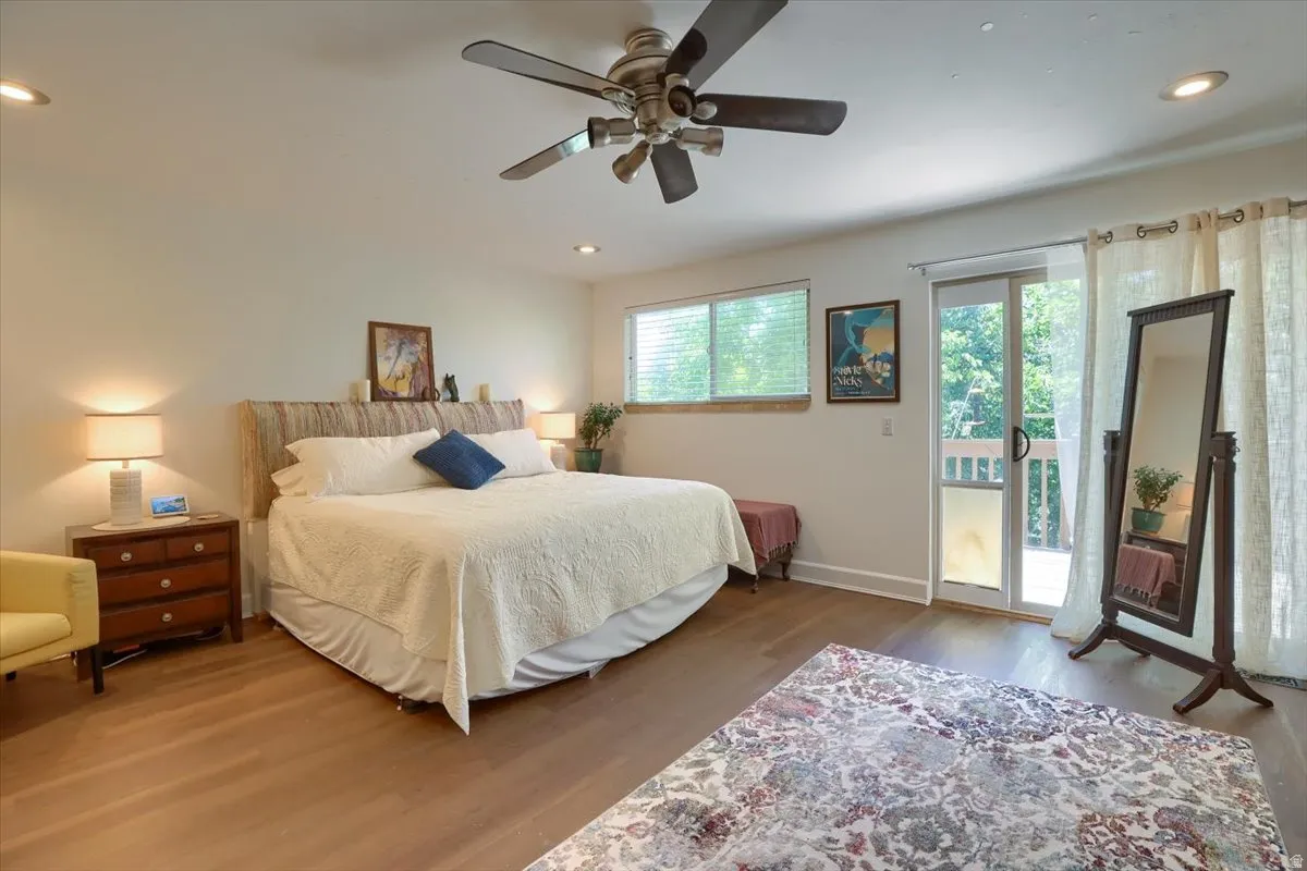 Spacious room featuring wood-finish flooring, recessed lighting, and a ceiling fan