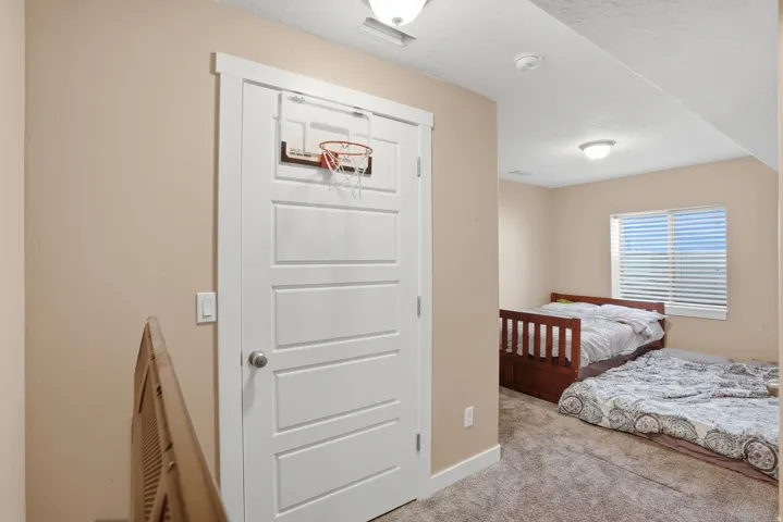 Bedroom featuring neutral wall paint, white trim, and a window with blinds