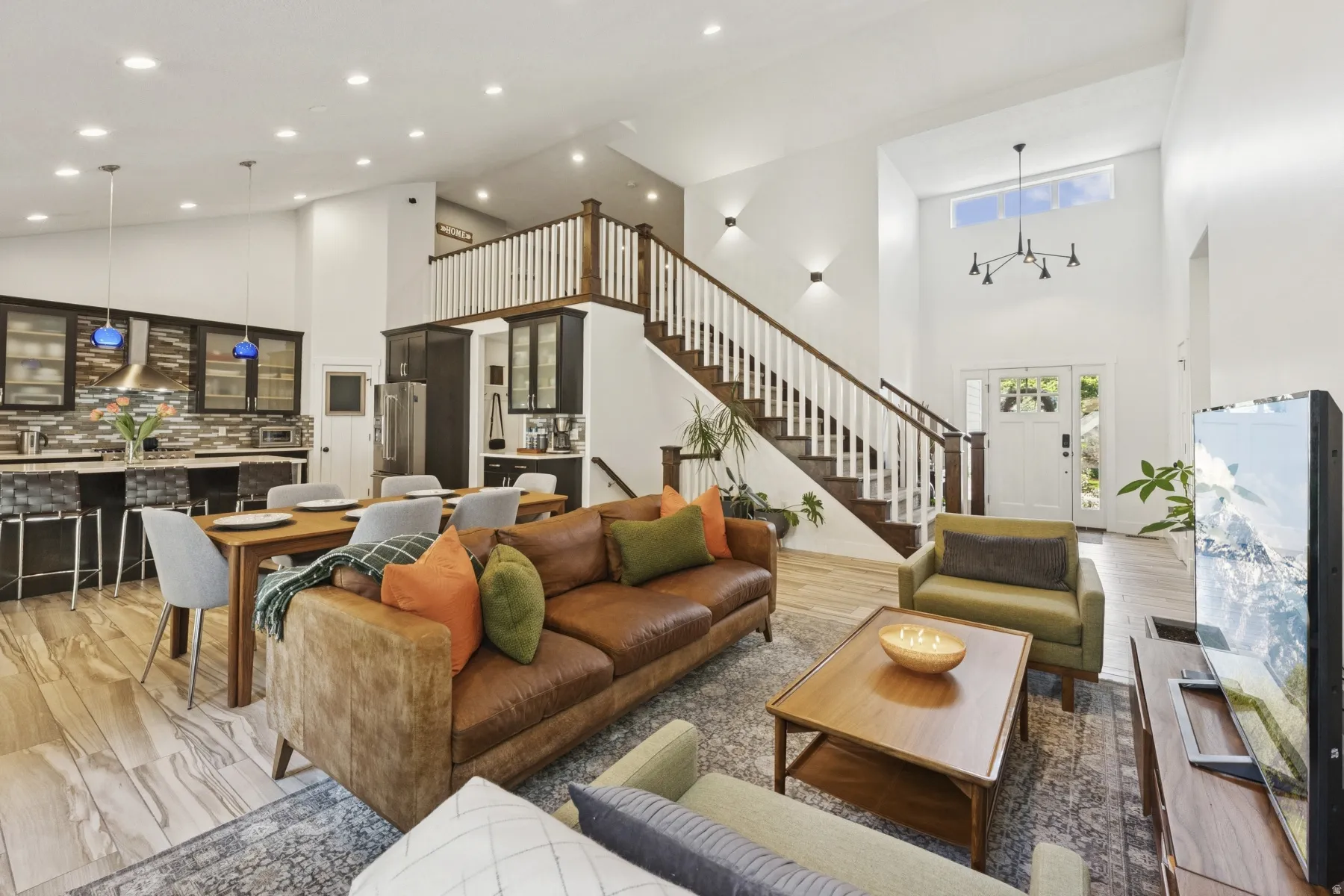 Living area with light wood finished floors, lofted ceiling, and recessed lighting