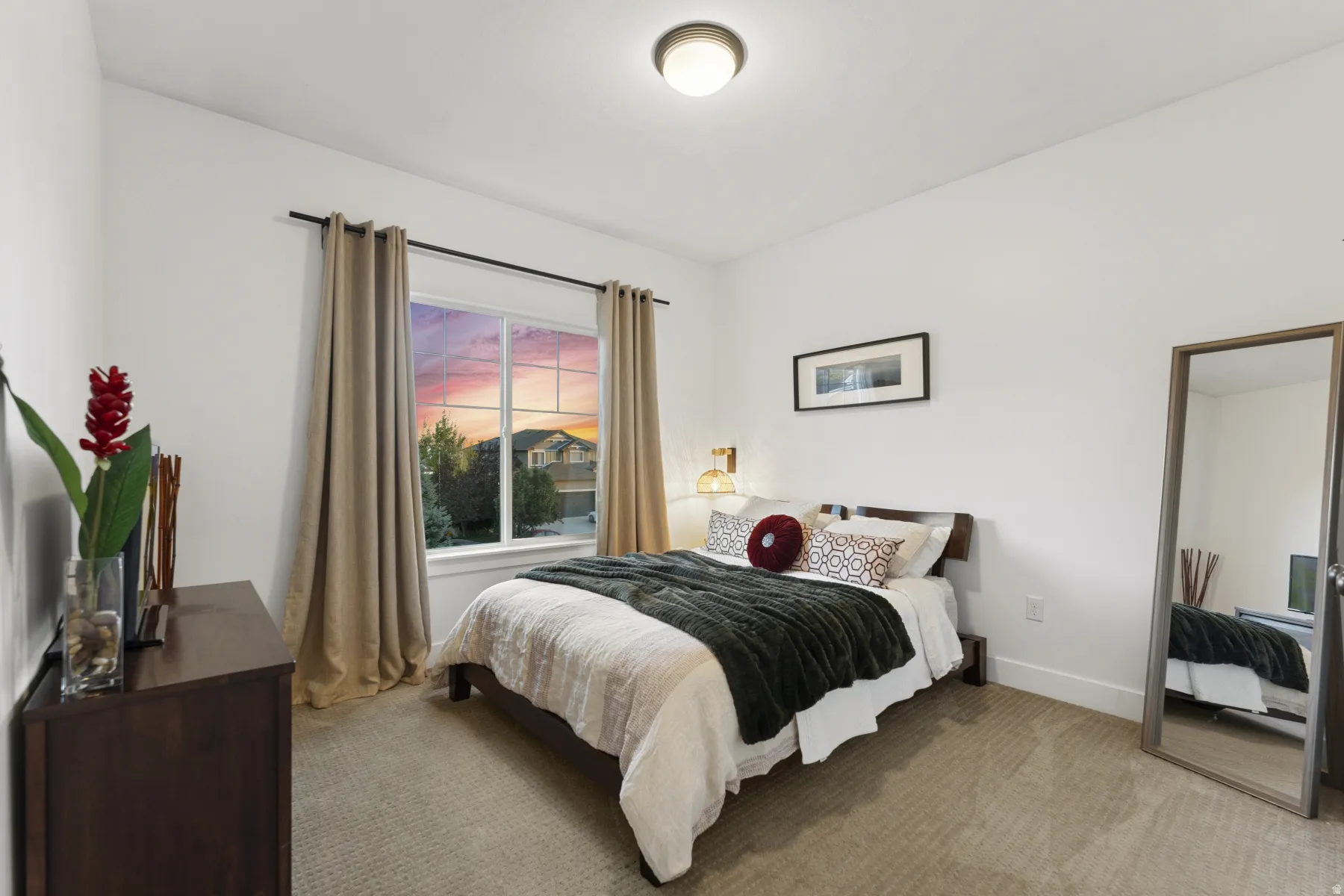 Bedroom with light carpet and baseboards
