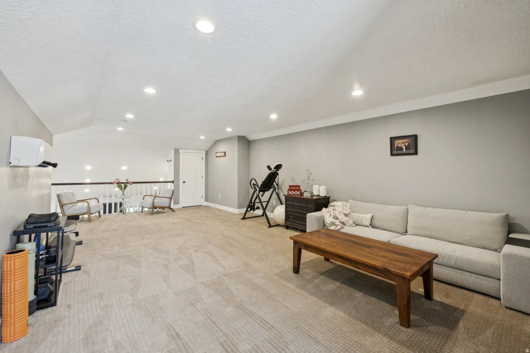 Living room featuring light colored carpet and recessed lighting