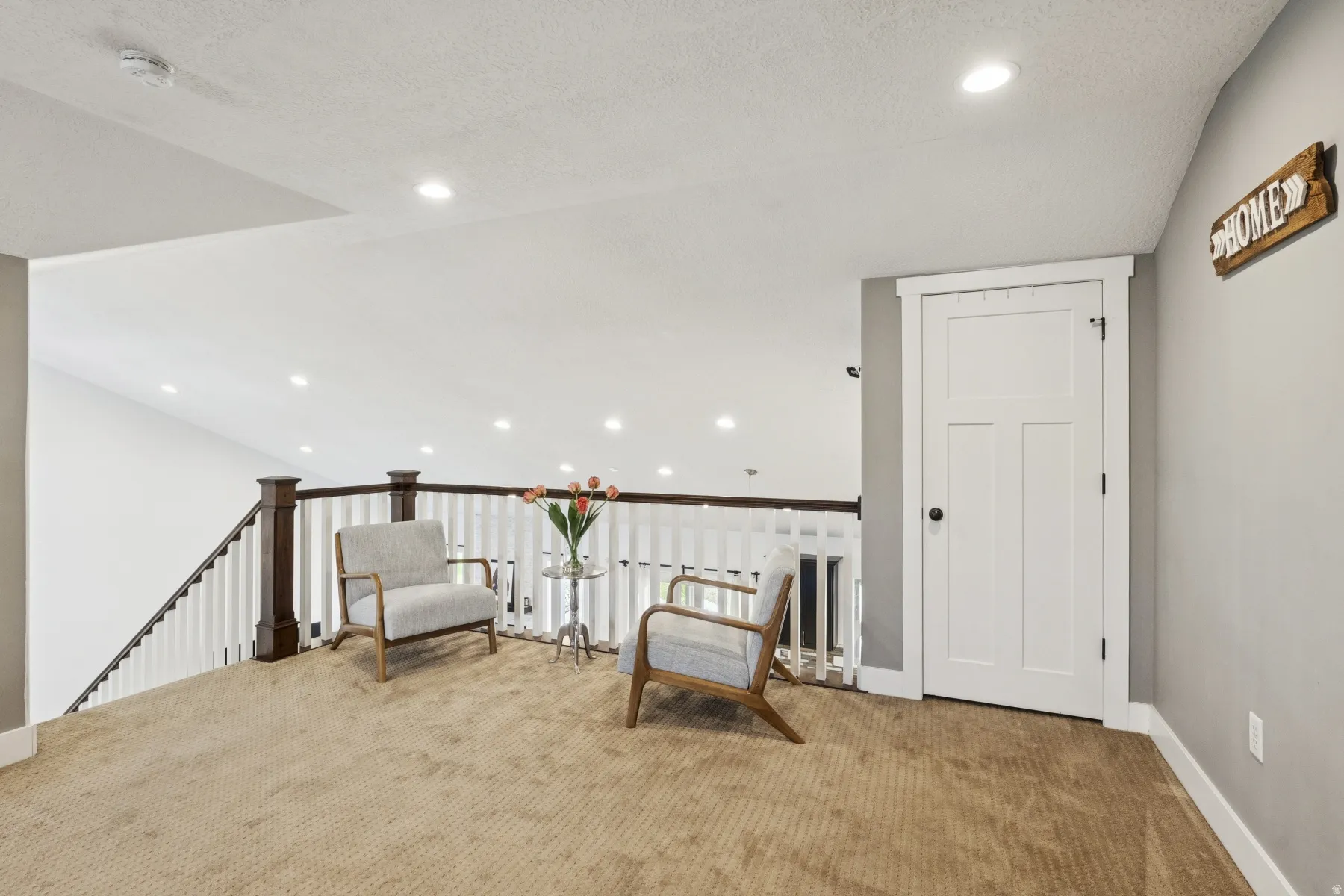 Unfurnished room with carpet floors, recessed lighting, and an upstairs landing