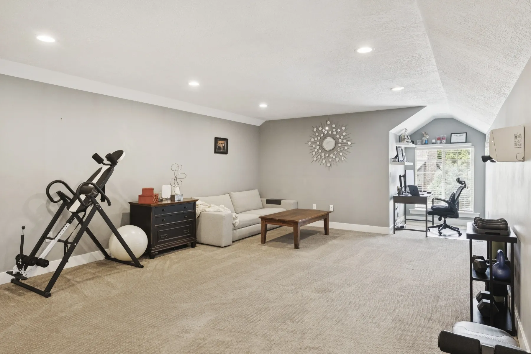 Living room with light colored carpet and recessed lighting