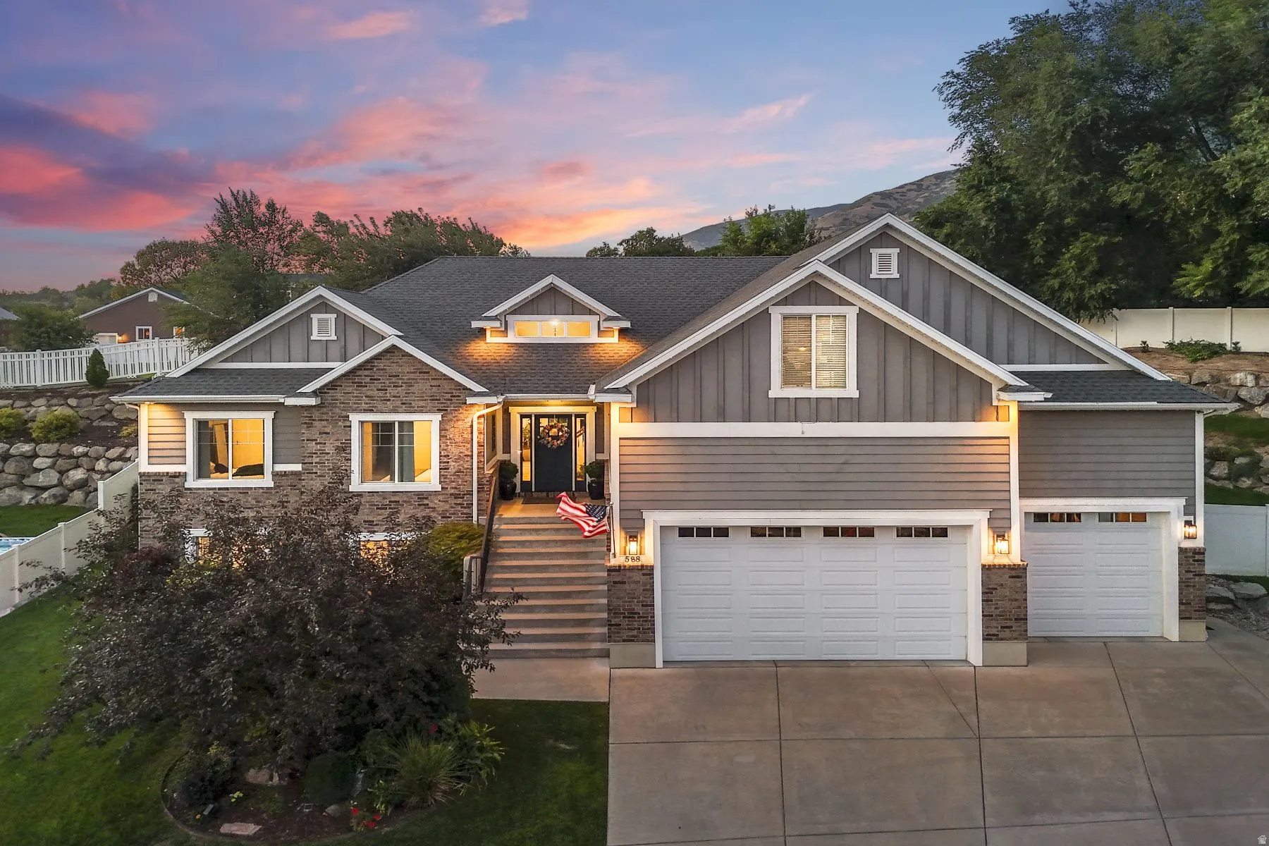 Craftsman inspired home with board and batten siding, concrete driveway, a garage, and roof with shingles