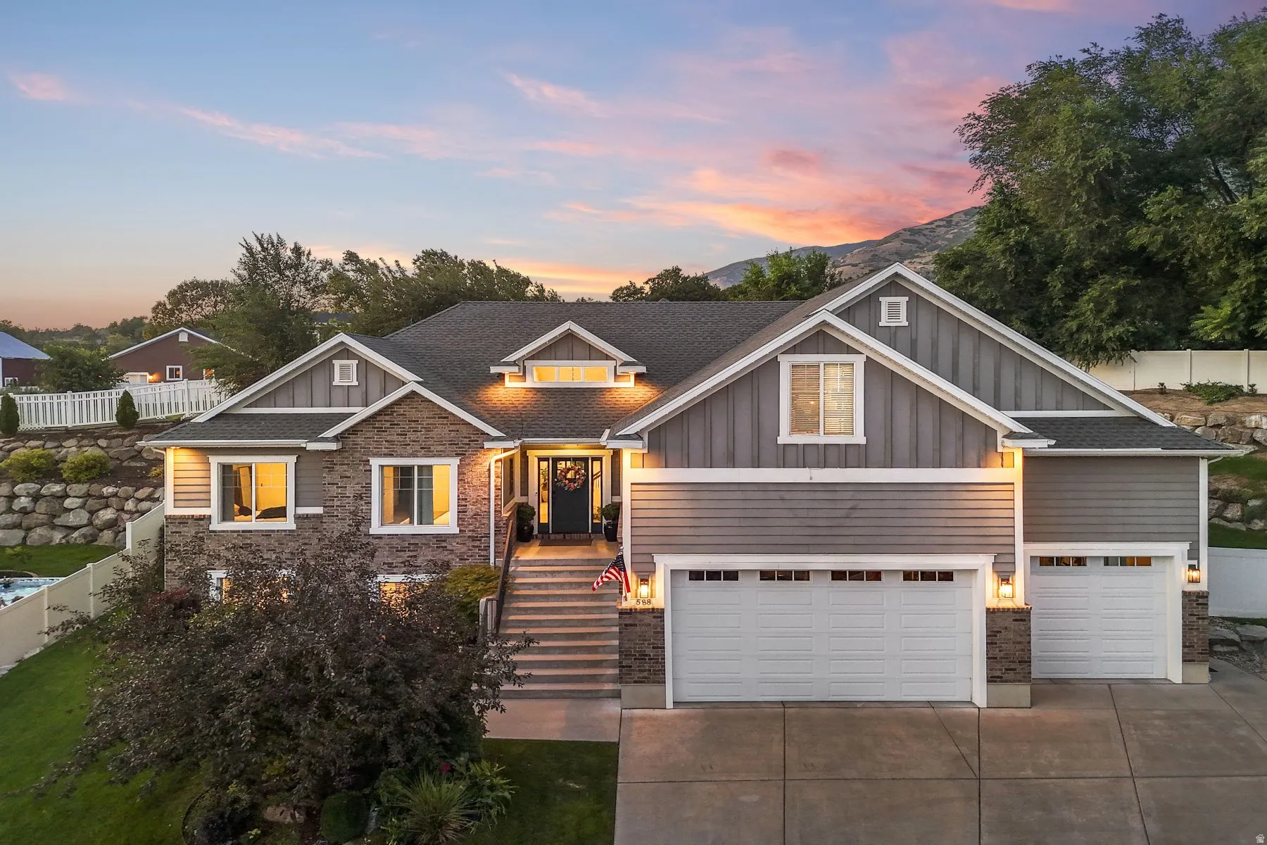 Craftsman-style home with board and batten siding, concrete driveway, a garage, and a shingled roof