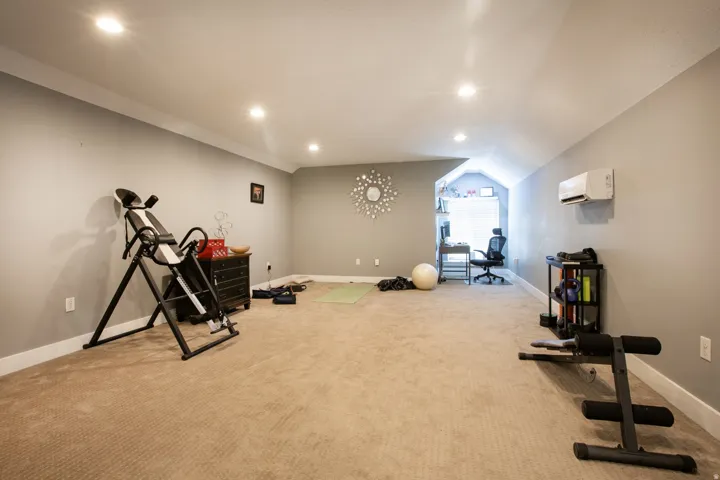 Spacious room featuring neutral carpeting and light gray walls