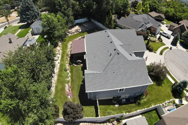 Contemporary single-family residence with a gray shingle roof and light blue siding