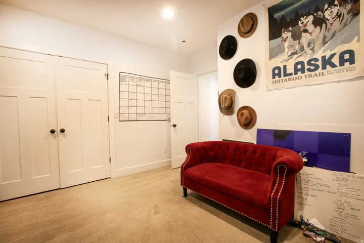 White interior doors featuring black hardware and neutral-toned carpeting