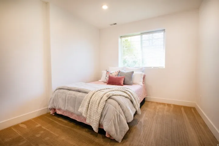 Room featuring neutral wall tones, recessed lighting, and a single window with blinds