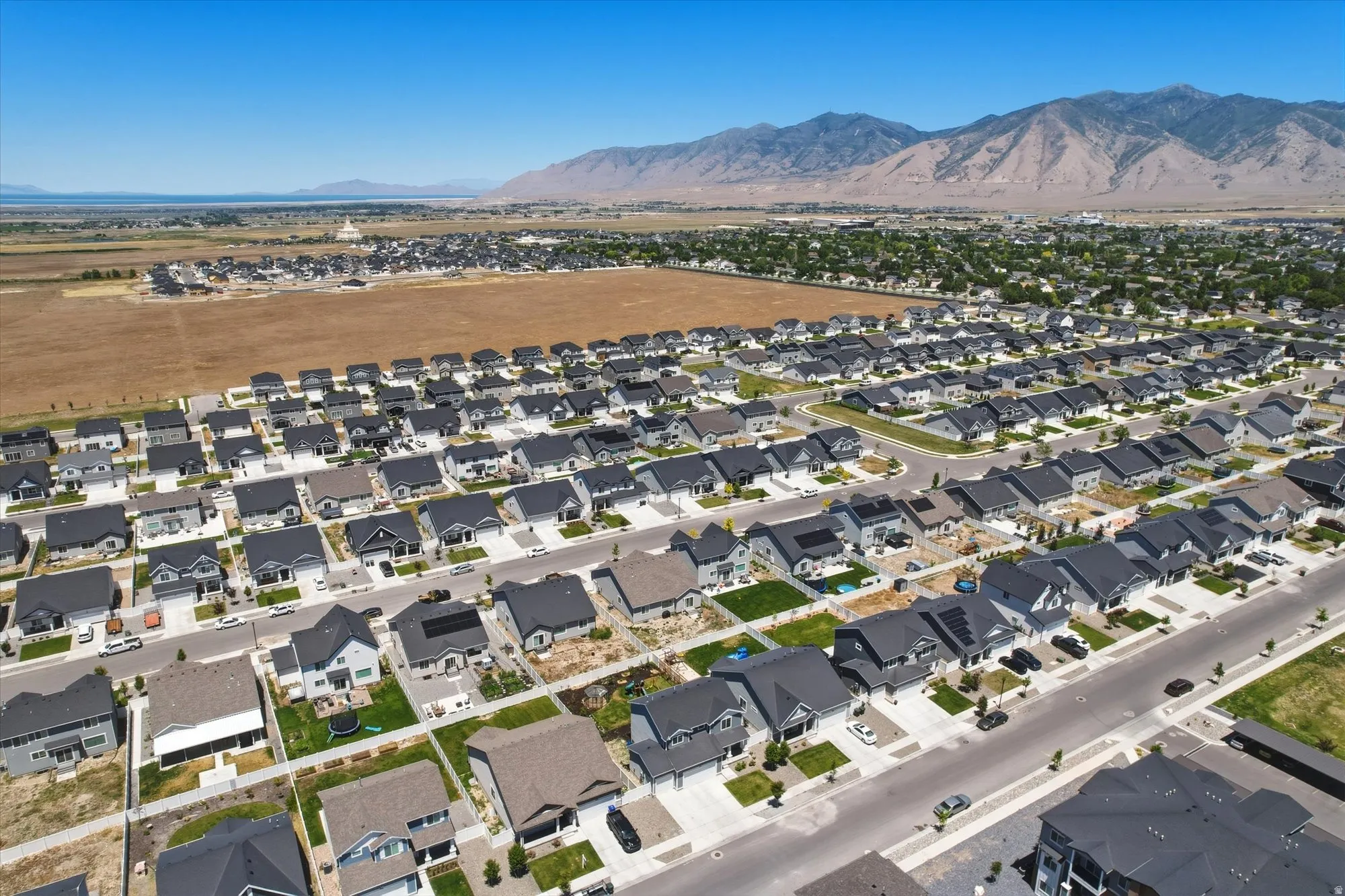 Aerial perspective showcasing a developed residential neighborhood with a mountain backdrop