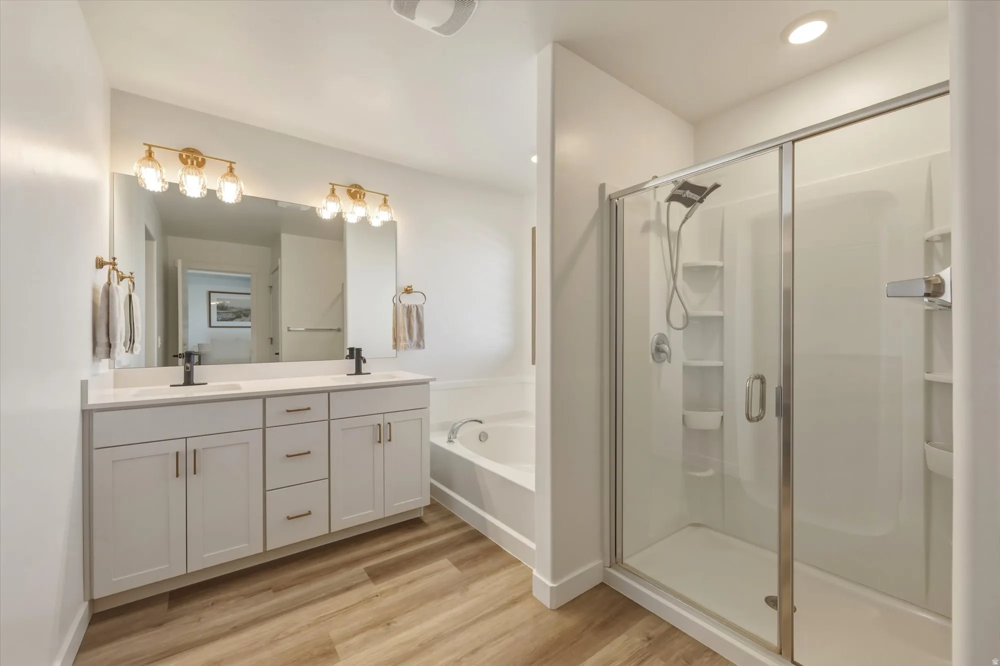 Contemporary bathroom featuring a spacious glass-enclosed shower, a separate soaking tub, and a dual-sink vanity with white cabinetry