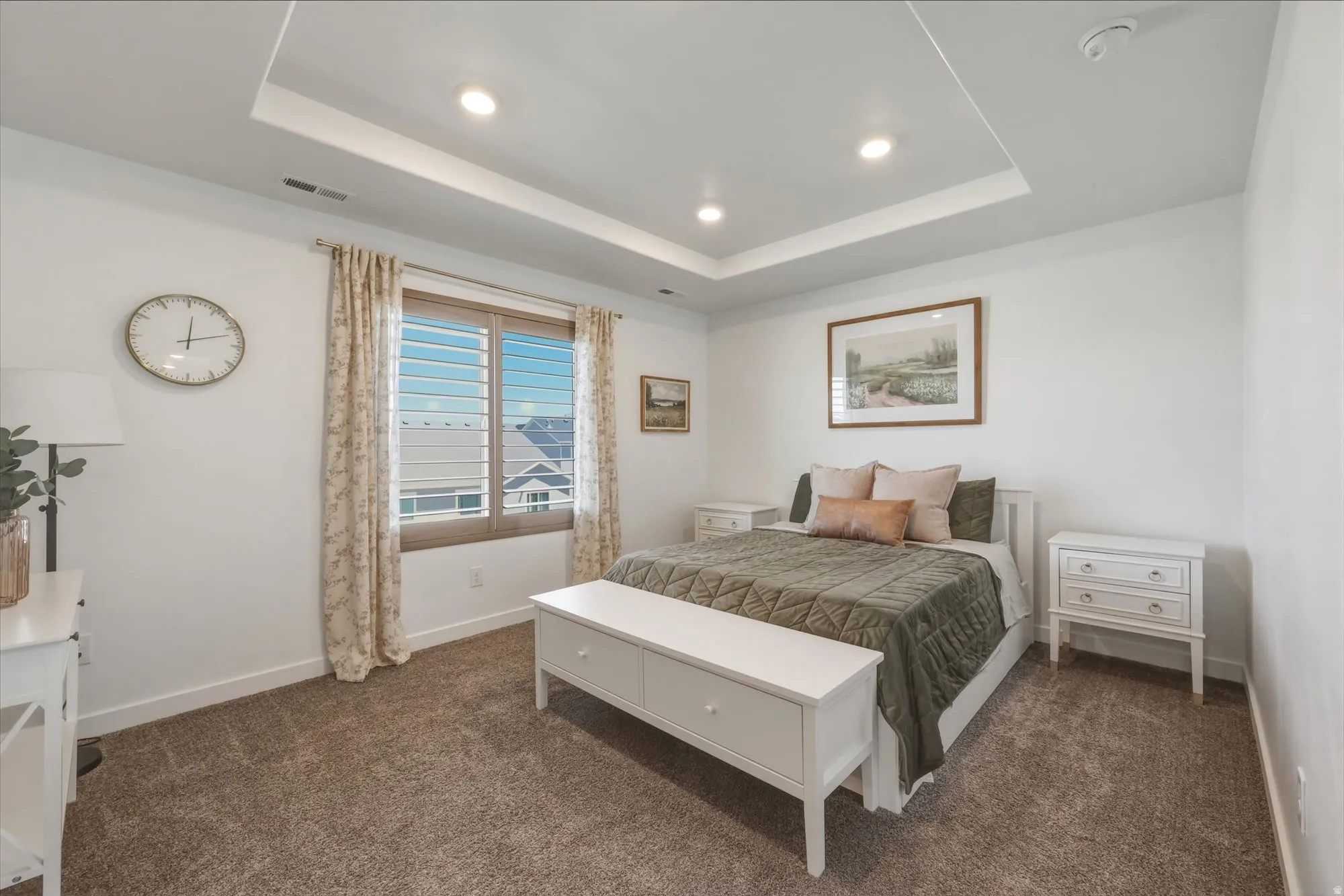 Recessed lighting illuminates a tray ceiling