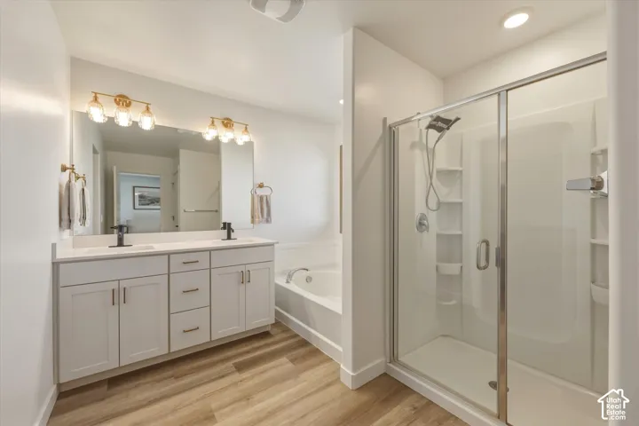 Contemporary bathroom featuring a spacious glass-enclosed shower, a separate soaking tub, and a dual-sink vanity with white cabinetry
