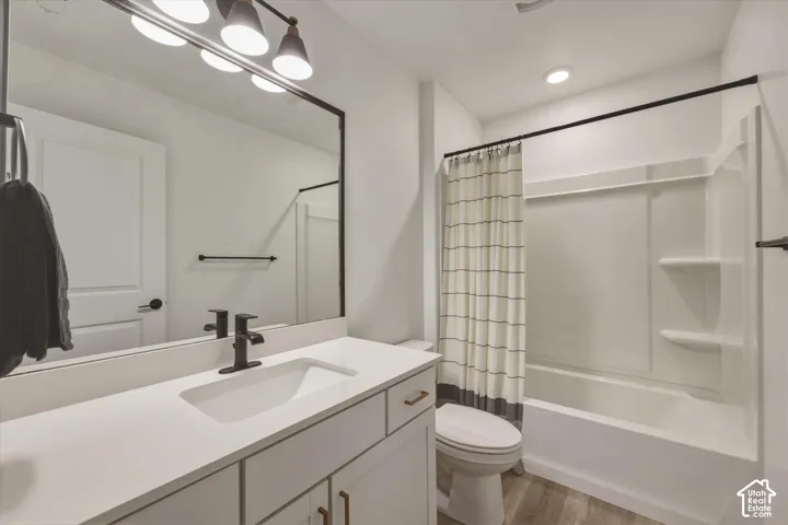 Bathroom featuring a single vanity with an integrated rectangular sink, matte black faucet, and white countertop