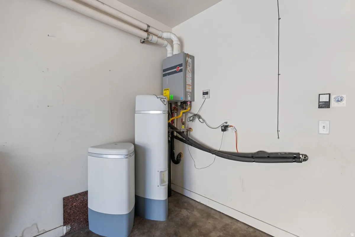 Tankless water heater installation with dedicated plumbing and utility connections