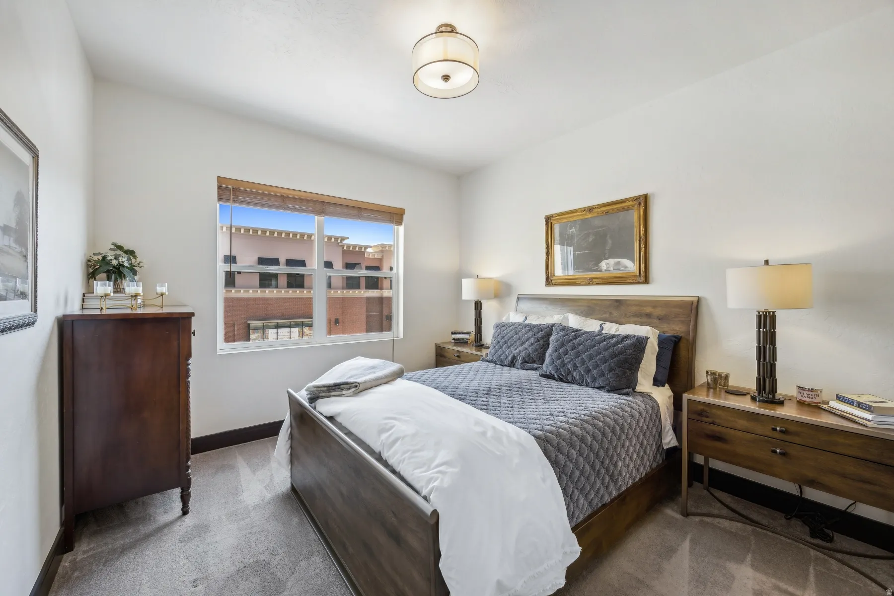 Bedroom featuring light-colored walls and grey carpet flooring