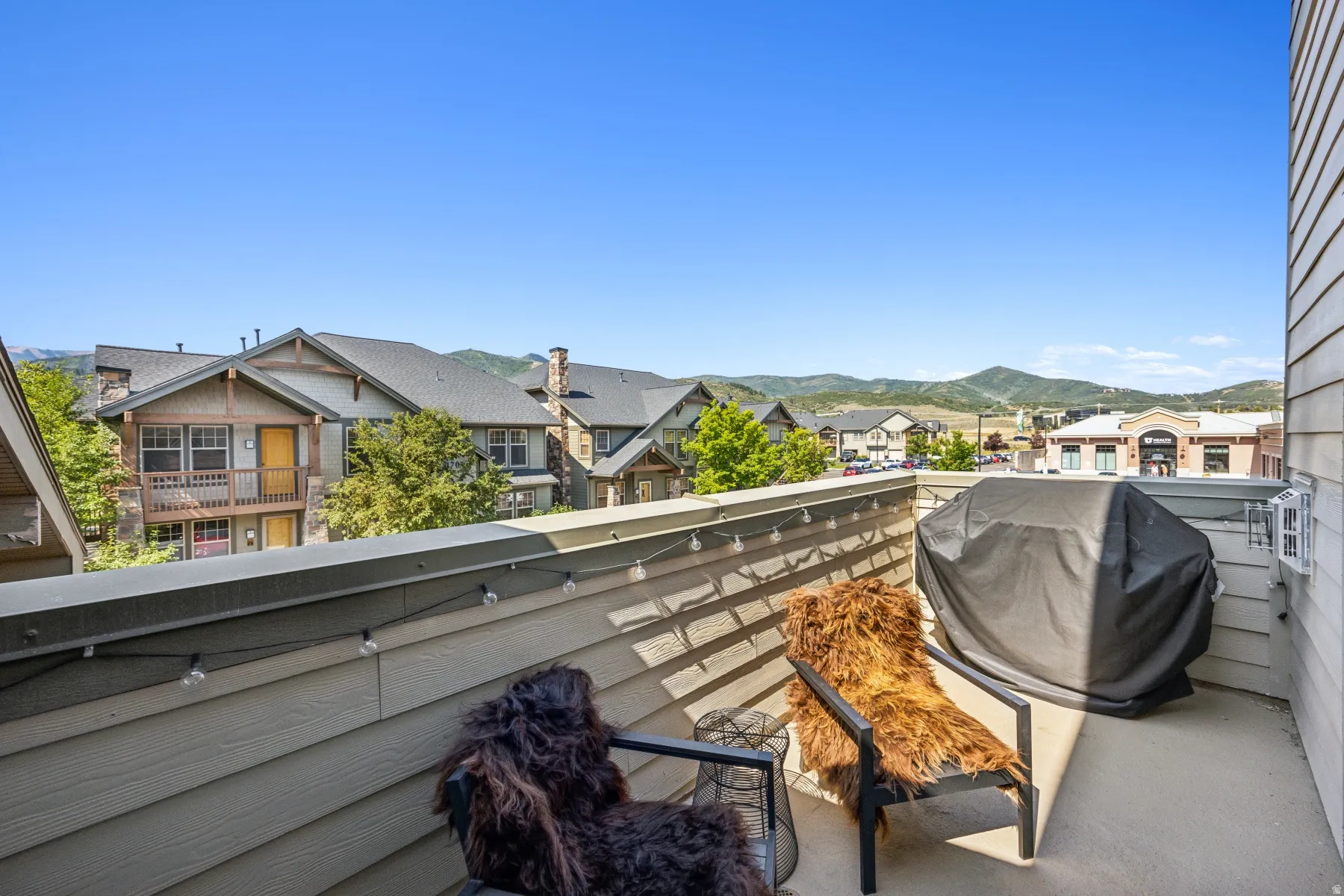 Outdoor balcony featuring composite siding and string lighting