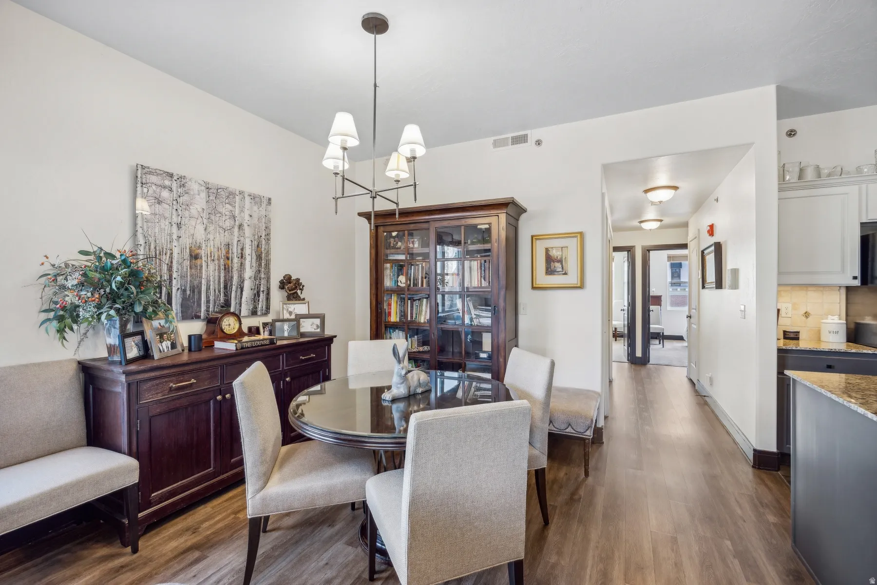 Dining area featuring wood-finish flooring, a contemporary chandelier, and recessed lighting