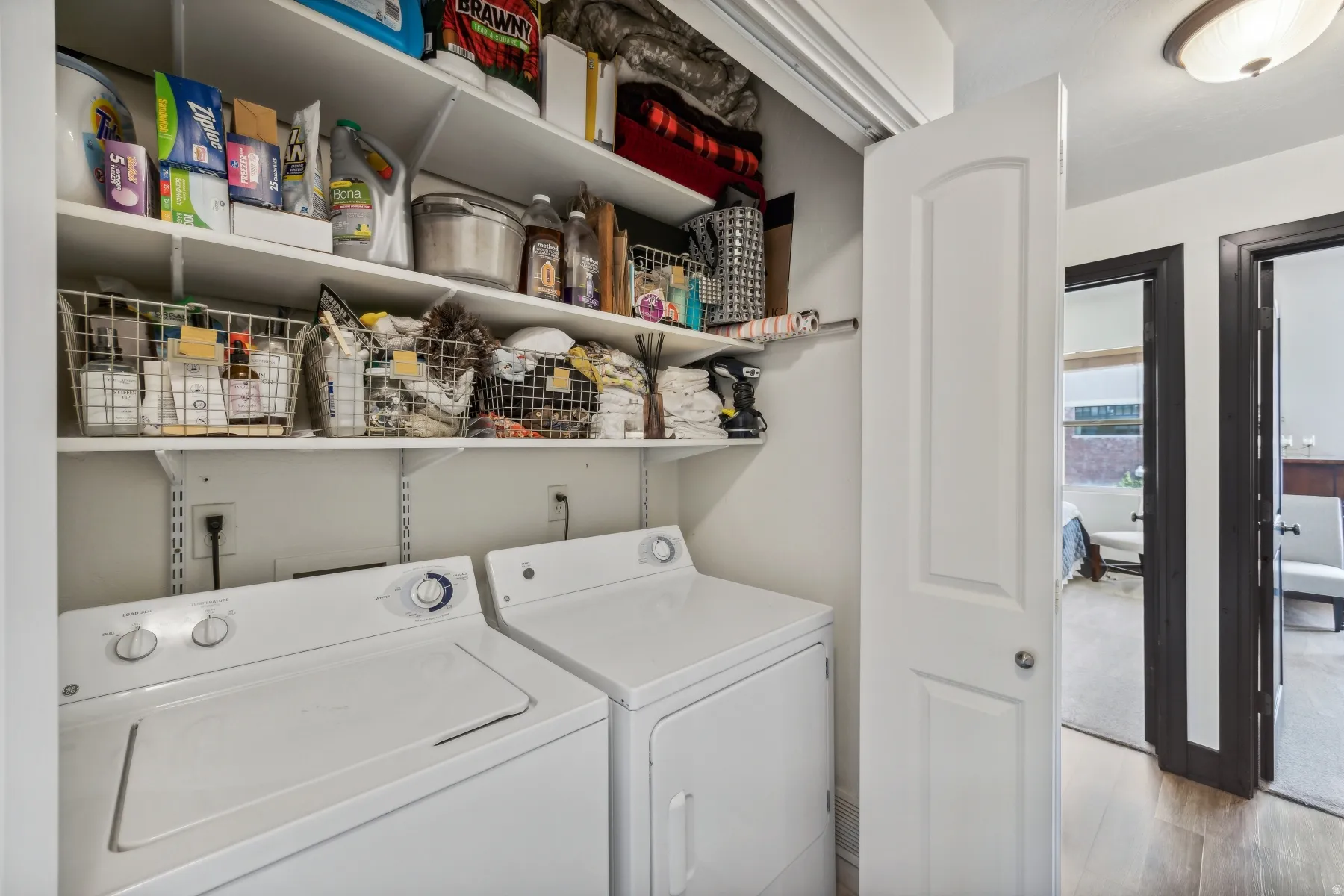 Dedicated laundry area featuring a white top-load washer and front-load dryer
