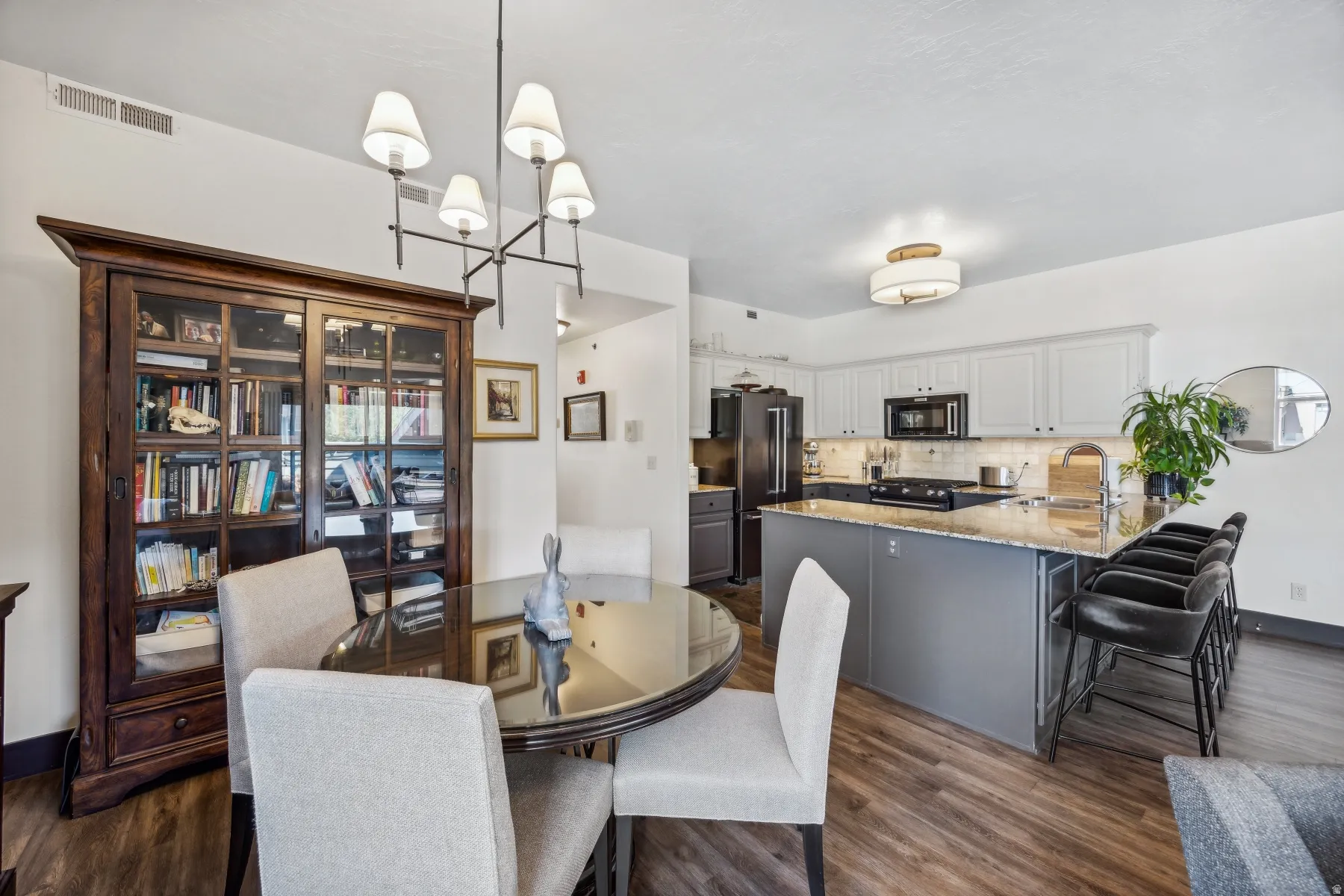 Kitchen and dining area featuring wood-finish flooring