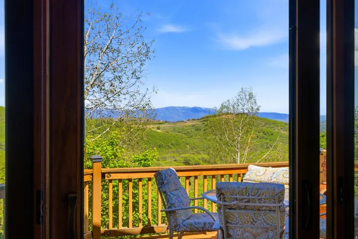 Outdoor deck with wood railing and slatted balusters
